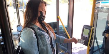 Woman using contactless to pay for the bus